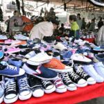 Vendor displaying shoes to attract the customer at Bacha Khan Chowk.