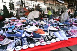 Vendor displaying shoes to attract the customer at Bacha Khan Chowk.