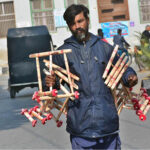 A vendor displaying wooden toys to attract the customers at Cantonment Road.