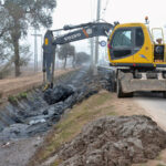 Worker is busy cleaning the Canal with the help of Machinery at the old Shujaabad road.