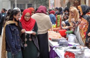 Students enjoying different saltish food items from a stall during "Meena Bazaar" at Women's University.
