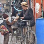 A students buying food items from street vendor at school holiday time.