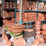 Woman purchasing clay-made items to attract customers in the Federal Capital