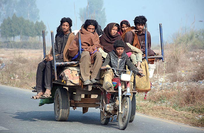 An underage rider with Family riding a motorcycle cart loader at Jaranwala Road which may cause a mishap and needs the attention of concerned authorities.
