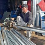 A skilled person making steel pipe and other items for the firewood stove at his work place as per increased demand in winter session.