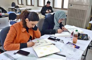 Student of Pakistan Institute of Fashion and Design finalizing her project.