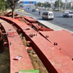 Workers busy in joining pedestrian bridge to be installed at Srinagar Highway in Federal Capital.