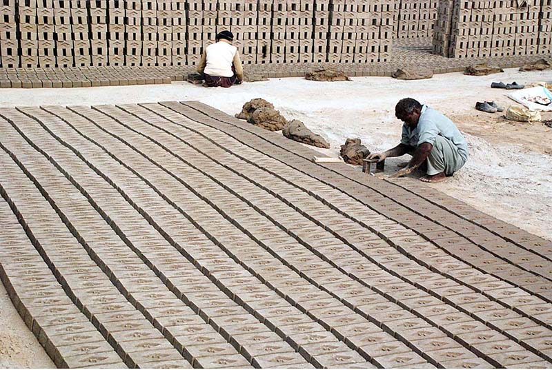 Laborers busy in preparing bricks at local bricks kiln
