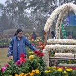 Visitor taking a keen interest in flowers during the annual Gul Dawoodi flower show at Qila Kuhna Qasim Bagh