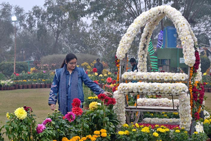 Visitor taking a keen interest in flowers during the annual Gul Dawoodi flower show at Qila Kuhna Qasim Bagh
