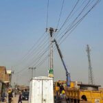 IESCO staffers busy in installing new electric wires at Sudran Road.