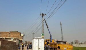 IESCO staffers busy in installing new electric wires at Sudran Road.