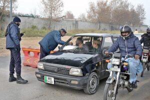 Police officials busy searching vehicles during routine security check in the Federal Capital