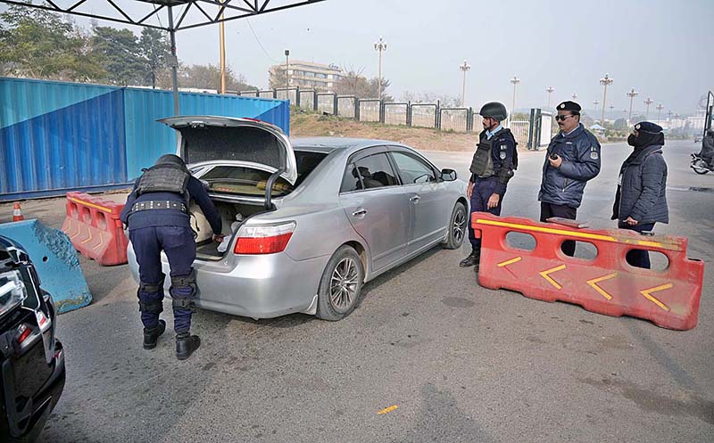 Police officials busy searching vehicles during routine security check in the Federal Capital