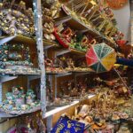 A shopkeeper arranging and displaying “Mehndi” related items to attract the customers at his shop in a local market
