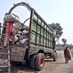 A labourer loaded old clothes on delivery truck at Hala Naka Road.