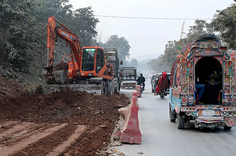 Labourers busy in construction work of Park Road with the help of heavy machineries during development work in the city