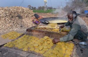 Farmers busy making traditional sweet item (Gurr) on his roadside setup at Kote Fareed Road
