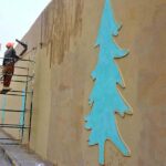 Worker busy paint on wall of Aabpara Underpass in the Federal Capital.