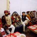 Brides and grooms sit together during a mass marriage ceremony held in Railway ground, a total of 122 couples from the Hindu community across Pakistan took their wedding vows during the mass wedding ceremony organized by the Pakistan Hindu Council