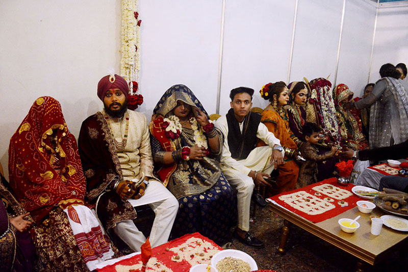 Brides and grooms sit together during a mass marriage ceremony held in Railway ground, a total of 122 couples from the Hindu community across Pakistan took their wedding vows during the mass wedding ceremony organized by the Pakistan Hindu Council
