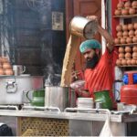A vendor busy in making a tea for customers in the city