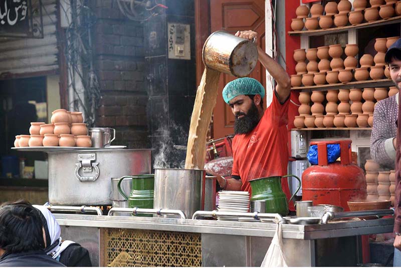 A vendor busy in making a tea for customers in the city