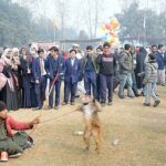 A juggler with his pet monkey showing tricks during Gur Mela at the University of Agriculture Faisalabad organized by Directorate of Farms.