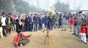 A juggler with his pet monkey showing tricks during Gur Mela at the University of Agriculture Faisalabad organized by Directorate of Farms.