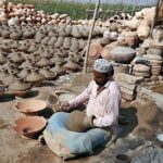 Craftsman preparing clay-made pitchers at his workplace at kumharpara.
