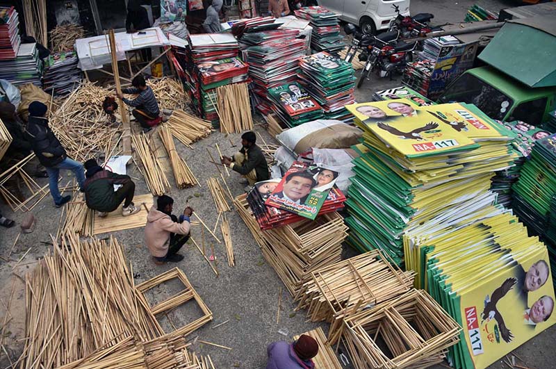 Workers busy in preparing election posters of the different parties and candidates at their workplace ahead of the upcoming General Elections-2024