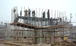 Workers busy in construction work of a flyover bridge on Jhumra Road near Abdullahpur