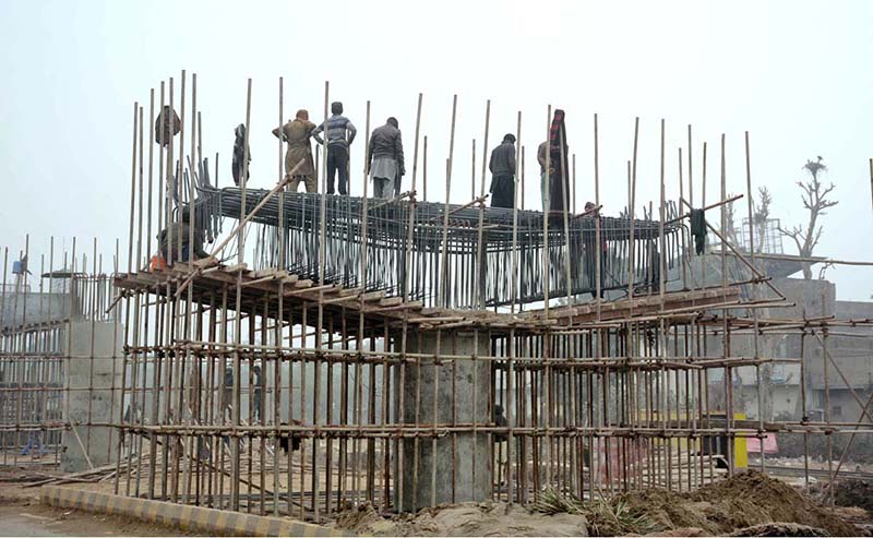 Workers busy in construction work of a flyover bridge on Jhumra Road near Abdullahpur