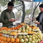 A vendor displaying fresh fruit on his motorcycle in Federal Capital.