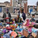 A roadside vendor displaying toys to attract the customers at Makki Shah Road