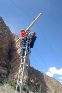 Water and Power department staffer busy in installing new electricity poll at the road side