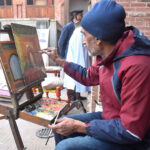 Artist giving final touch to his painting