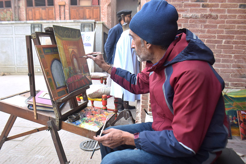Artist giving final touch to his painting