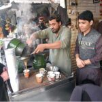 A vendor preparing tea for his customers in a local hotel at G-9 Markaz.