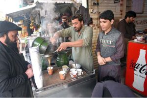 A vendor preparing tea for his customers in a local hotel at G-9 Markaz.