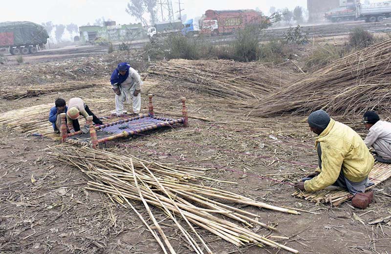 Workers are busy in making traditional curtains (chik) in their daily routine at their work place