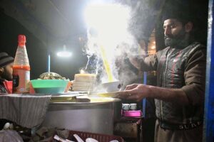 A vendor displaying chicken soup to attract the customers at his roadside setup during winter season in the Provincial Capital.
