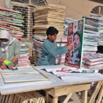 Vendor making panaflex of candidates preparing for general election 2024.