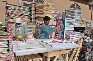 Vendor making panaflex of candidates preparing for general election 2024. 