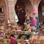 Woman busy in selecting and purchasing Household items at Delhi Gate.