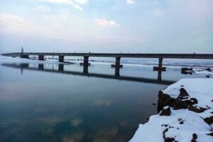 An attractive and eye catching view of Snow covered RCC Bridge along with Indus River during first snow fall in the catchment area of Pakistan.