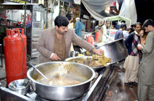 A vendor displaying and selling traditional food at Anarkali Bazar. 