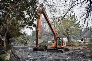 Workers busy in cleaning the Canal with the help of Machinery near Mall road in the Provincial Capital