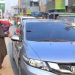 A man selling and displaying red roses to the customer at Sadar road