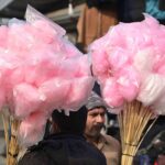 A woman vendor displaying balloons to attract the customers at Friday Bazaar, Peshawar Mor in Federal Capital
